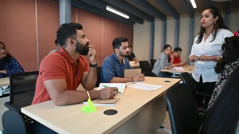 Students attending a practical training session with a teacher in class.