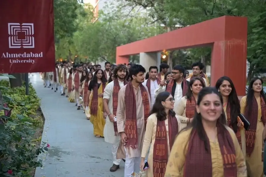 Students at Ahmedabad University walking together during an academic event.